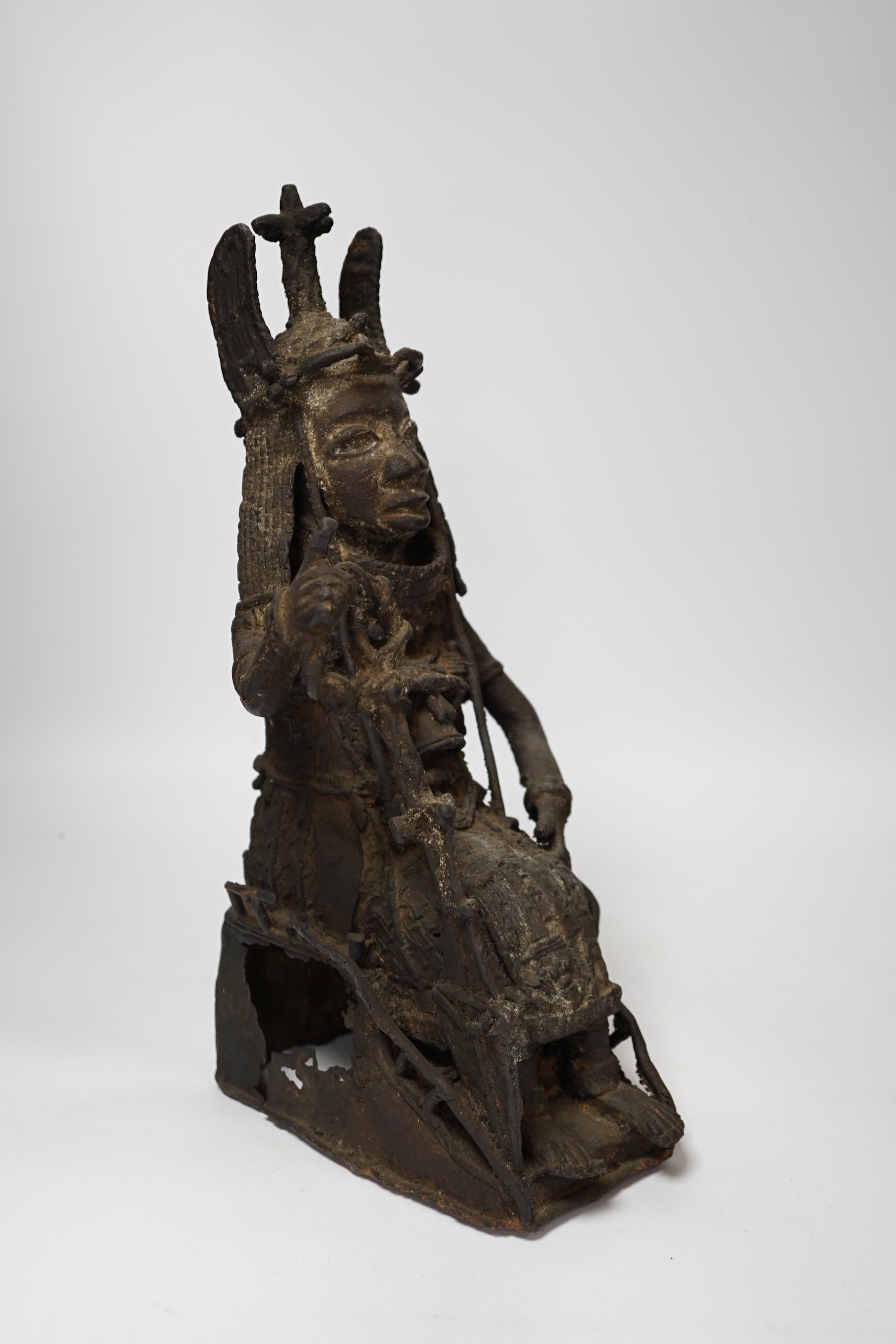 A 19th century Benin bronze of a seated figure, 38cm high